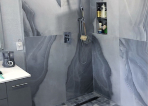 Modern showr design featuring stunning grey marble large slab tile and coordinating floor tiles.